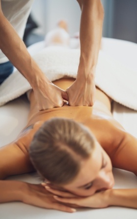 relaxed woman receiving massage