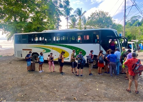 riders waiting to board bus