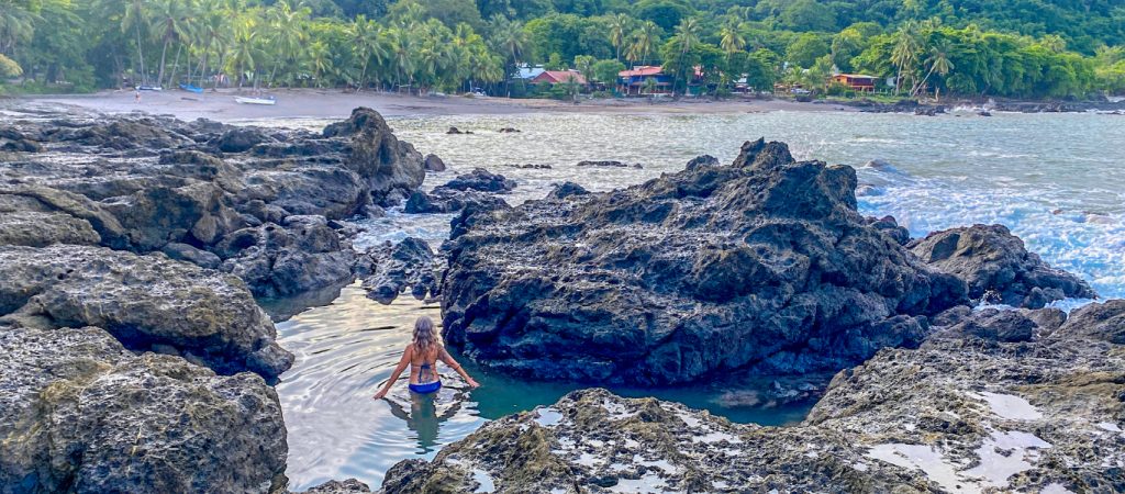 Woman wading in the Pico tide pool, Montezuma Costa Rica