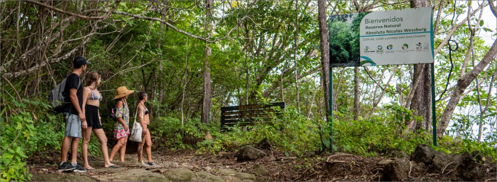 family of tourists looking at the Wessberg sign