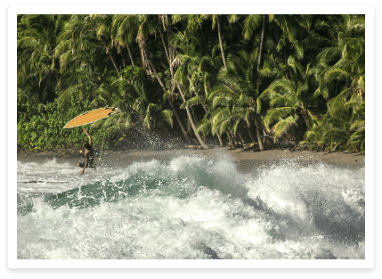surfer at Los Cedros with yellow board